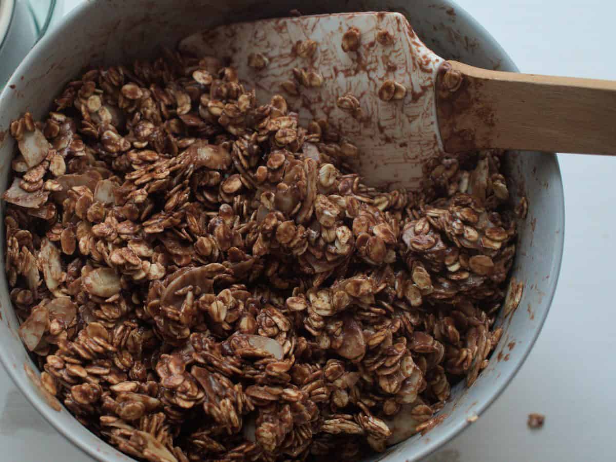 closeup of chocolate cherry sourdough granola in a bowl before baking