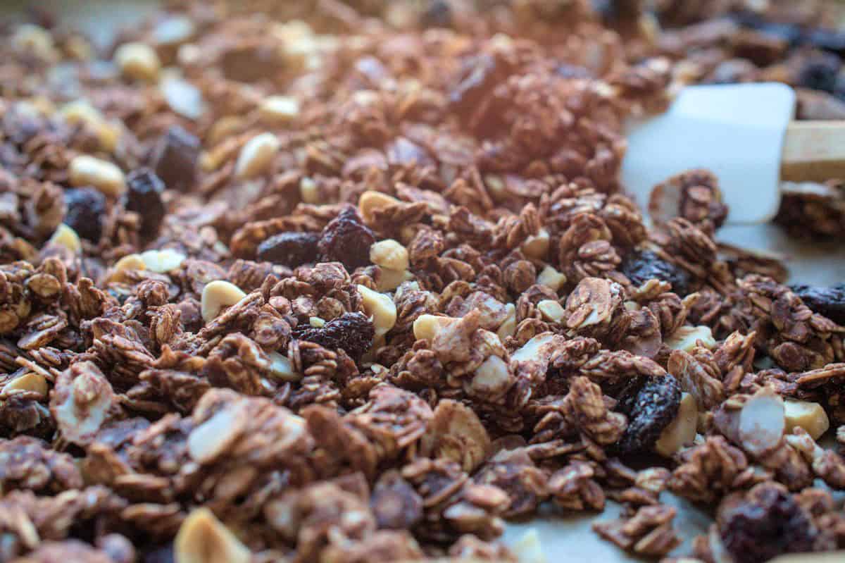 closeup of chocolate cherry sourdough granola on a baking sheet