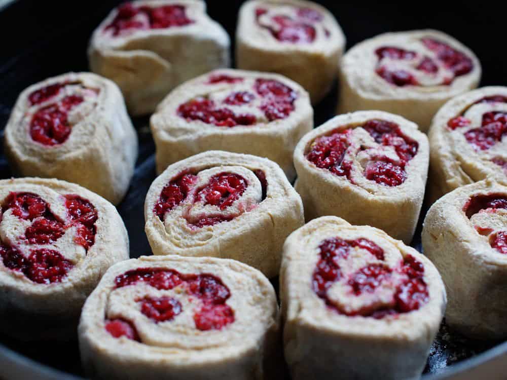 cut Lemon Raspberry Sourdough Sweet Rolls in a cast iron pan before baking