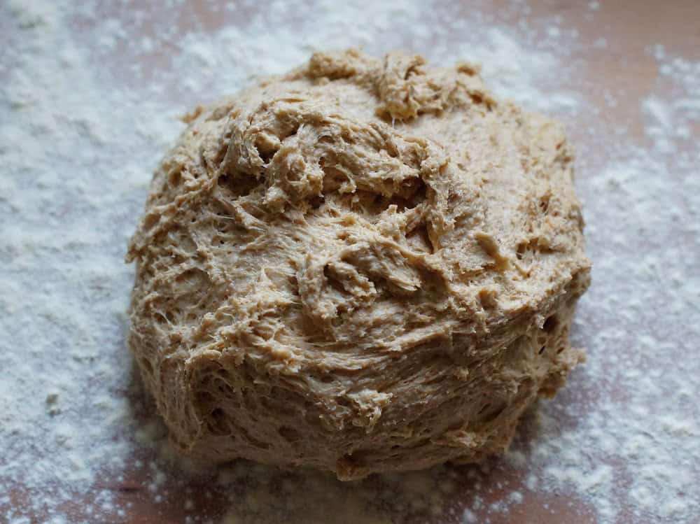 closeup of Lemon Raspberry Sourdough Sweet Rolls dough on a floured worktop before rolling out