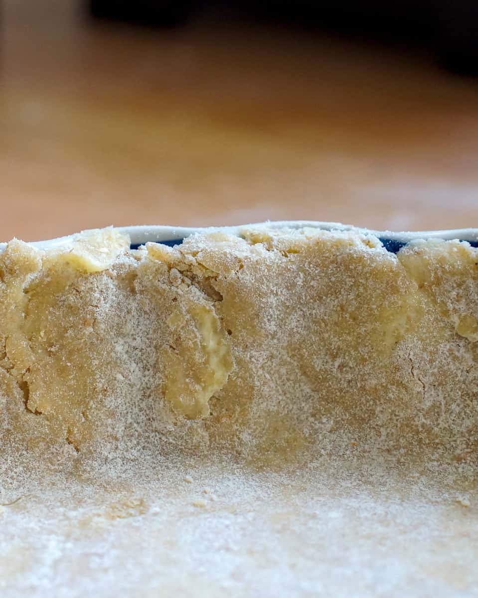 closeup of sourdough pie crust in the pan, patched at the rim