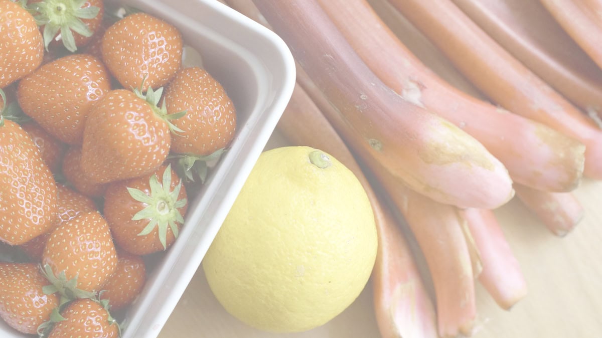 closeup of filling ingredients, highlighting the seasonal pink rhubarb, dark red strawberries and bright yellow lemon