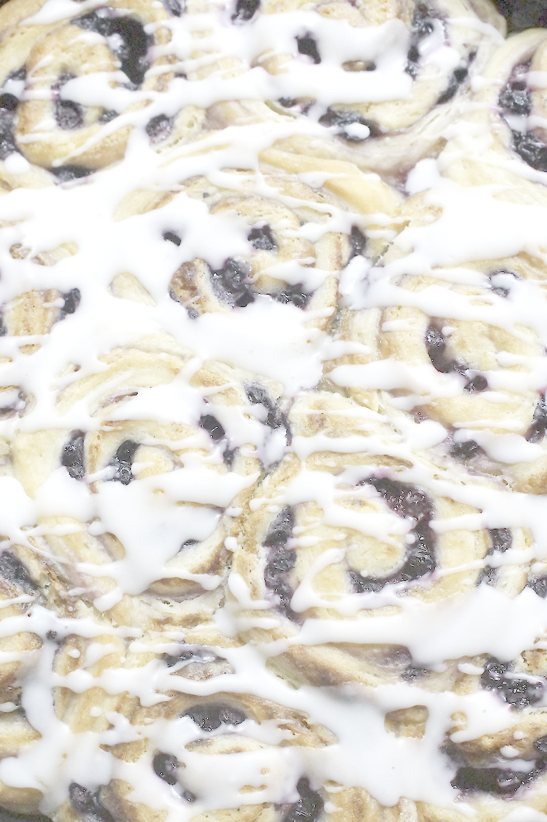 Golden baked sourdough berry rolls, topped with a yummy thick lemon glaze, poured over in  ribbons.