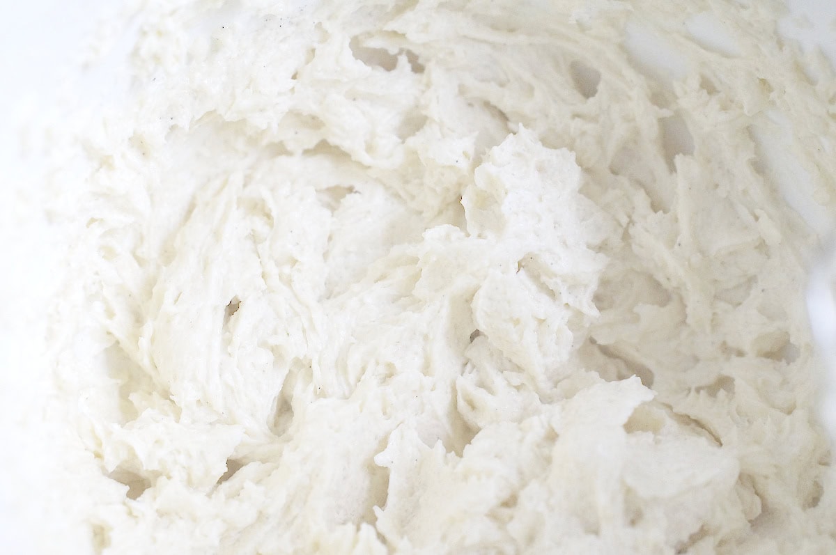 Close-up of vanilla-speckled sourdough discard batter in a mixing bowl.