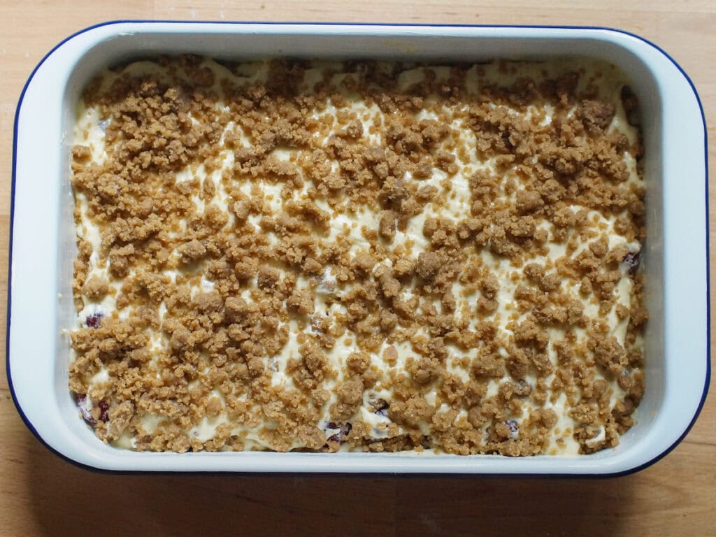 Assembled cake layers in a rectangular baking pan, ready for baking.
