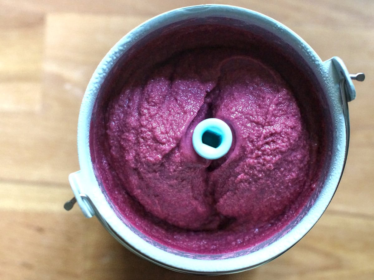 Vibrant purple blackberry Greek yogurt ice cream, churned to creamy perfection.