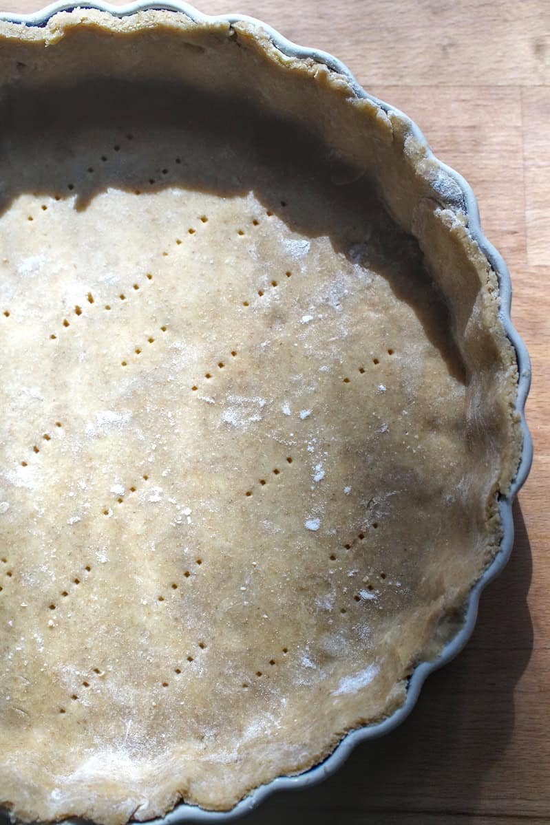 Golden Kamut sourdough pie crust in tart pan, ready for veggie quiche filling.