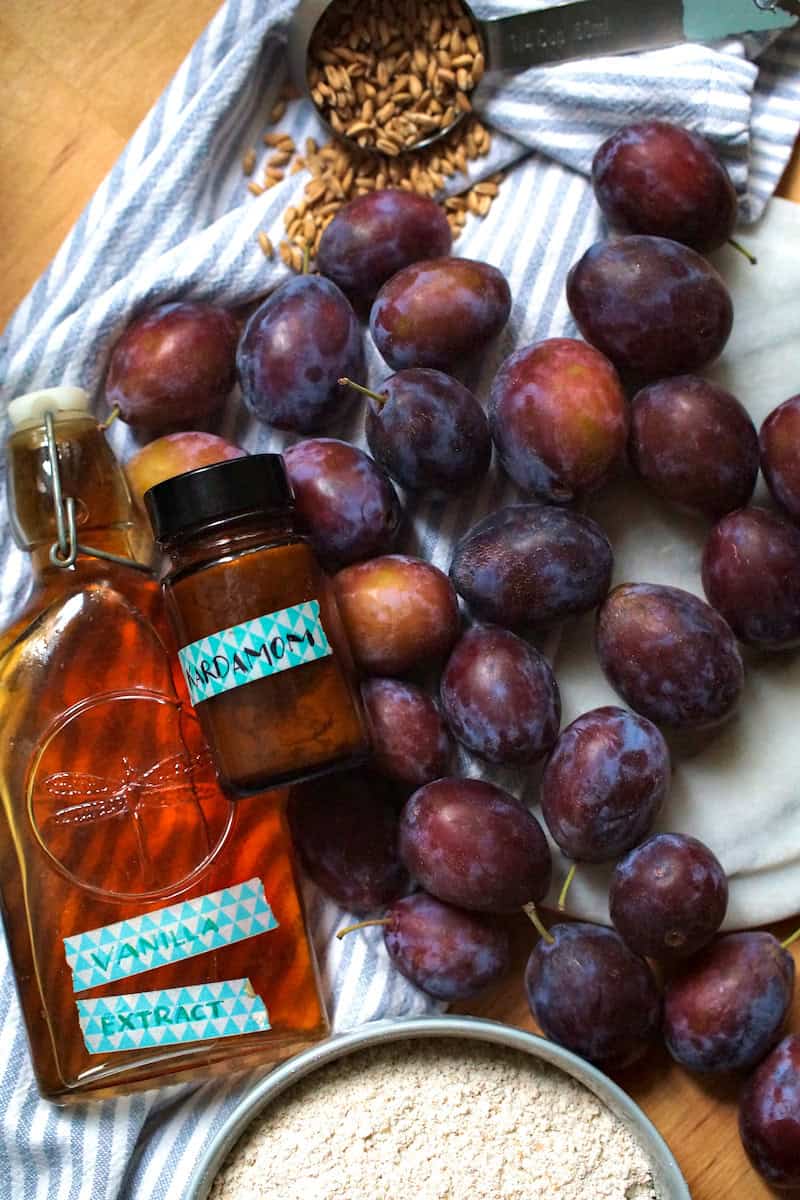 Fresh plums, vanilla extract, ground cardamom and freshly milled spelt flour are the core ingredients for this super soft fall buckle recipe.