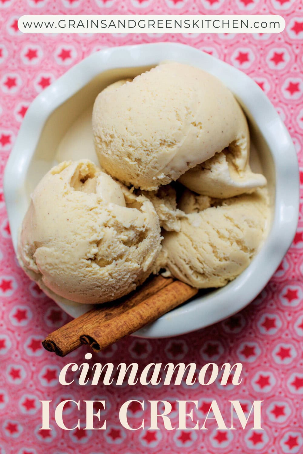Three scoops of creamy cinnamon ice cream in a white fluted bowl, garnished with cinnamon sticks, on a red-star tea towel.